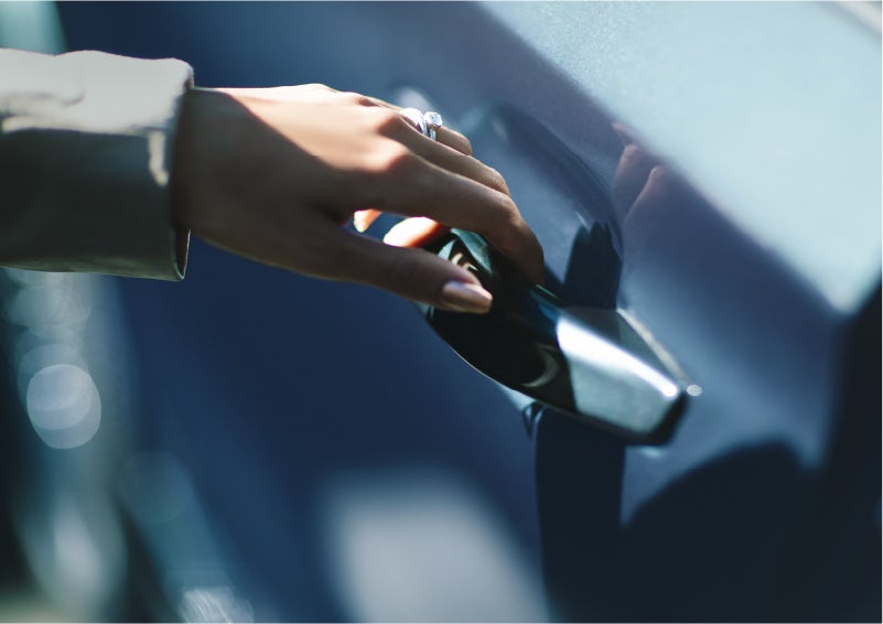 A hand gracefully grips the Light Touch Handle of a 2023 Lincoln Aviator® SUV to demonstrate its ease of use | Pinnacle Lincoln in Nicholasville KY