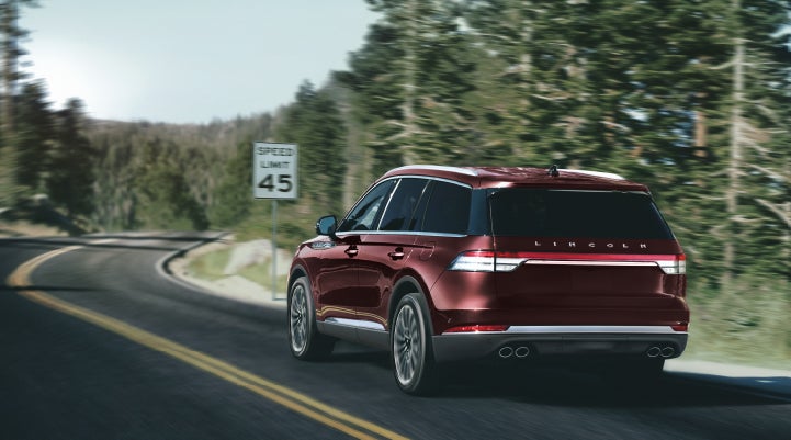 A 2024 Lincoln Aviator® SUV is being driven on a winding mountain road | Pinnacle Lincoln in Nicholasville KY