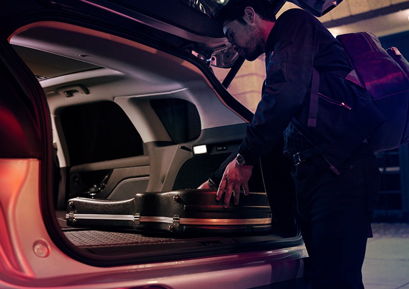 A man is shown loading cargo into the rear of a 2024 Lincoln Corsair® SUV with the second-row seats folded flat. | Pinnacle Lincoln in Nicholasville KY