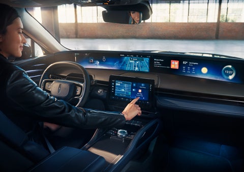 The driver of a 2024 Lincoln Nautilus® SUV interacts with the center touchscreen. | Pinnacle Lincoln in Nicholasville KY